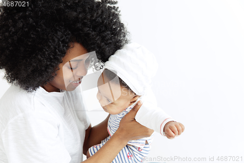 Image of Portrait of beautiful african woman holding on hands her little baby