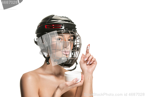 Image of Female hockey player in helmet and mask