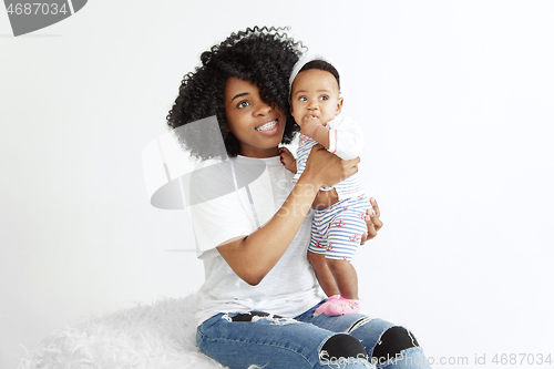 Image of Portrait of beautiful african woman holding on hands her little baby