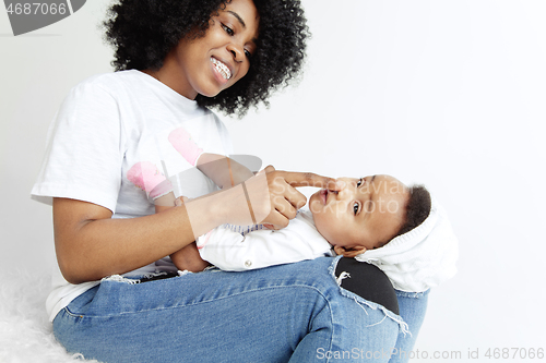 Image of Portrait of beautiful african woman holding on hands her little baby