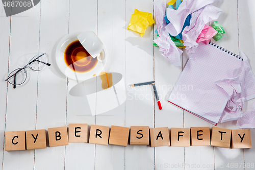 Image of Stationery and word CYBER SAFETY made of letters on wooden table