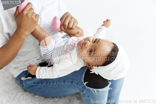 Image of Portrait of beautiful african woman holding on hands her little baby