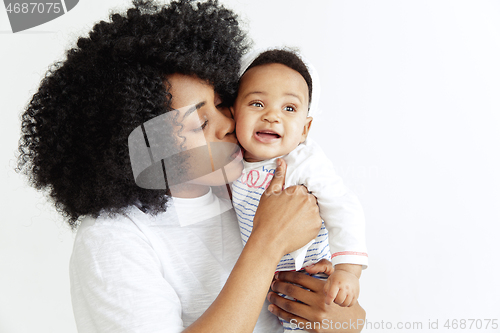 Image of Portrait of beautiful african woman holding on hands her little baby