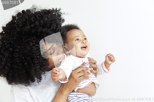 Image of Portrait of beautiful african woman holding on hands her little baby