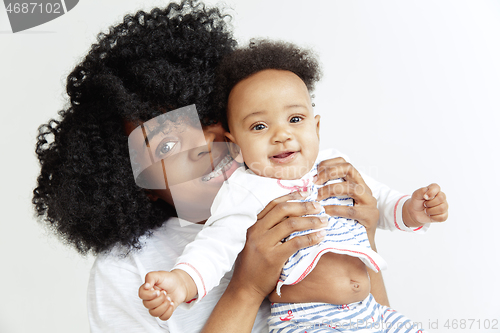 Image of Portrait of beautiful african woman holding on hands her little baby