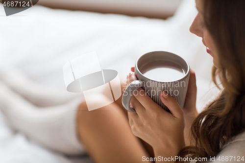 Image of close up of happy woman with cup of coffee at home