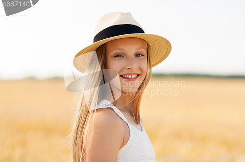 Image of portrait of girl in straw hat on field in summer