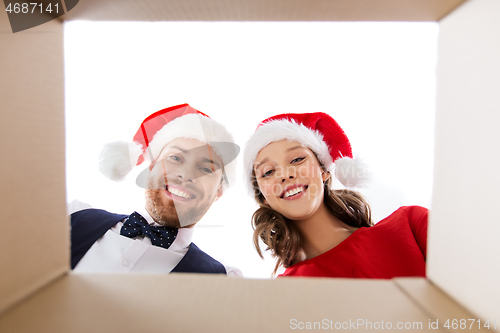 Image of happy couple opening christmas gift box