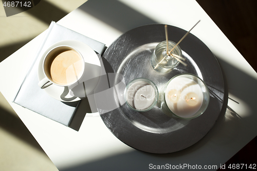 Image of coffee, candles and aroma reed diffuser on table