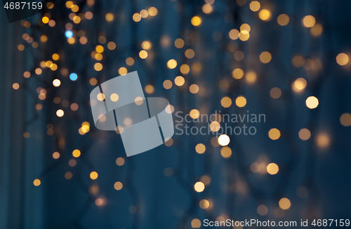 Image of christmas garland lights over dark blue background