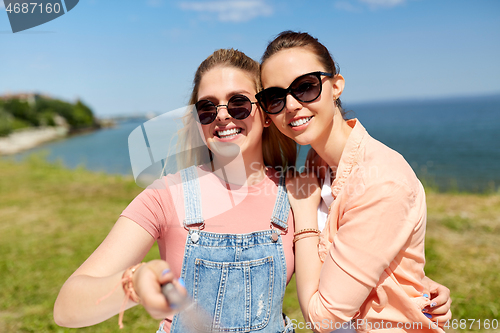 Image of teenage girls or friends taking selfie in summer