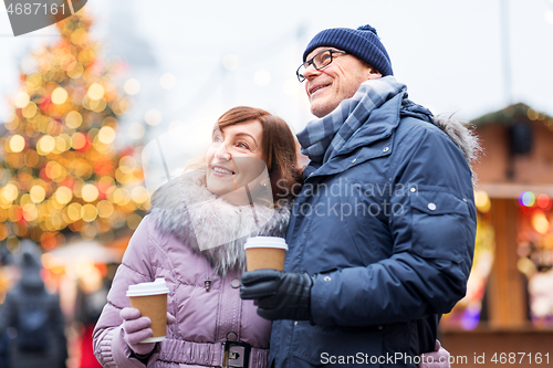 Image of senior couple with coffee at christmas market