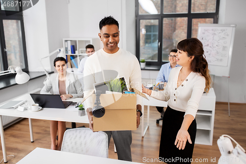 Image of new male employee with colleagues at office