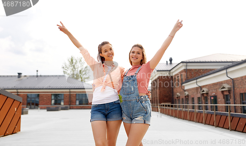 Image of teenage girls or friends on city roof top