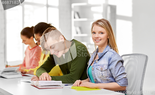 Image of high school students with books and notebooks