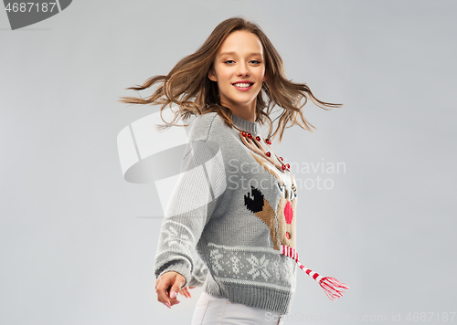 Image of woman dancing at christmas ugly sweater party
