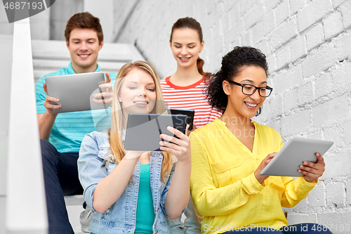 Image of high school students with tablet computers