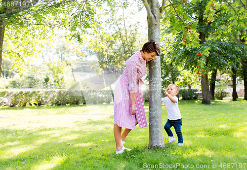 Image of happy mother and son having fun in summer park