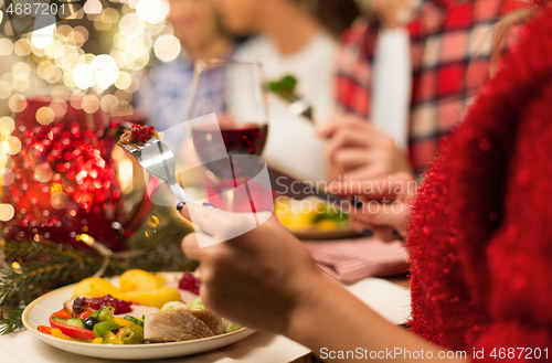 Image of close up of friends having christmas dinner