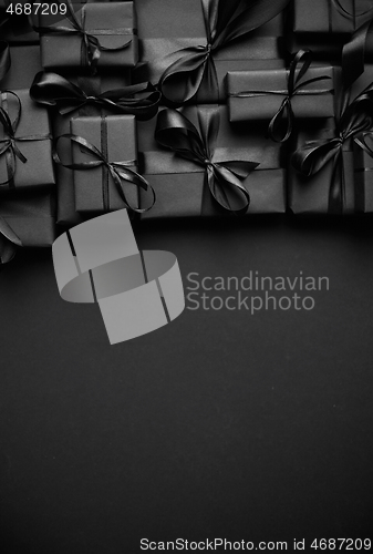 Image of A pile various size black boxed gifts placed on stack. Christmas concept.