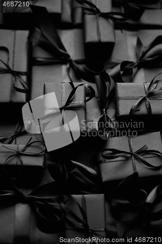 Image of A pile various size black boxed gifts placed on stack. Christmas concept.