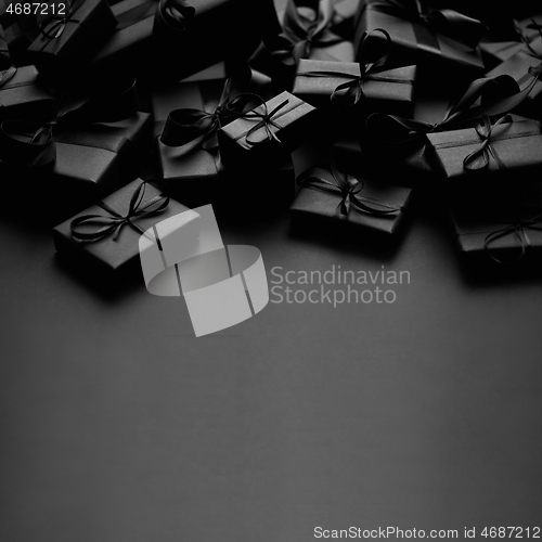 Image of A pile various size black boxed gifts placed on stack. Christmas concept.