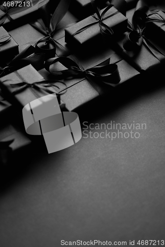 Image of A pile various size black boxed gifts placed on stack. Christmas concept.