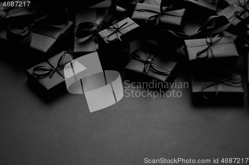 Image of A pile various size black boxed gifts placed on stack. Christmas concept.