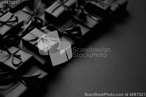 Image of A pile various size black boxed gifts placed on stack. Christmas concept.