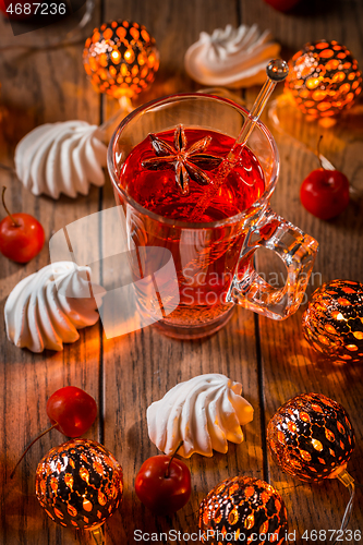 Image of Spicy winter tea or punch with anise and meringue pastry