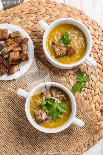 Image of Traditional French onion soup with toasted bread croutons 