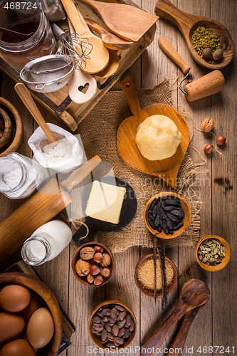 Image of Assortment of baking ingredients and kitchen utensils in vintage wooden style