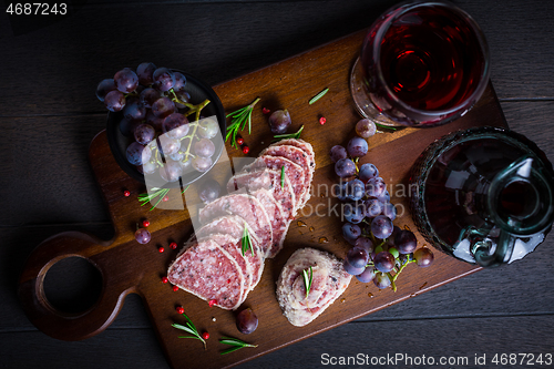 Image of Saltufo - Italian salami delicacy, salami with summer truffle coated with Parmesan cheese with red wine and grapes