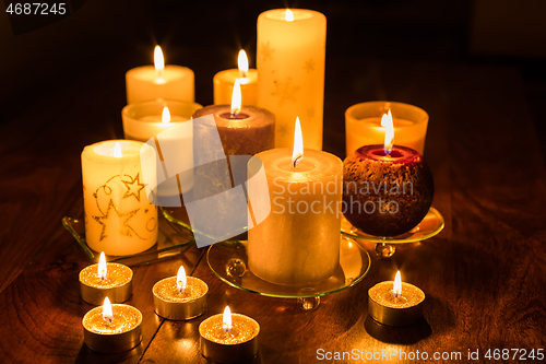 Image of Candles on wooden background. Candlelights for Christmas.