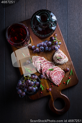 Image of Saltufo - Italian salami delicacy, salami with summer truffle coated with Parmesan cheese with red wine and grapes