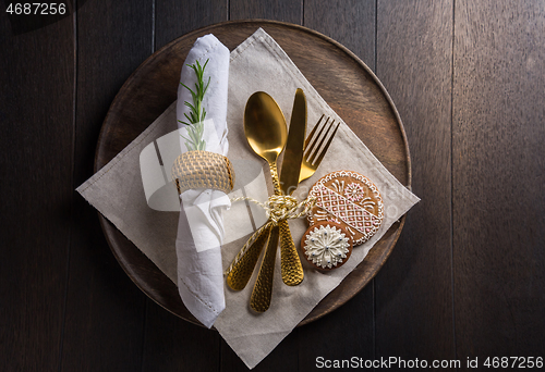 Image of Christmas table place setting with vintage silverware and gingerbread