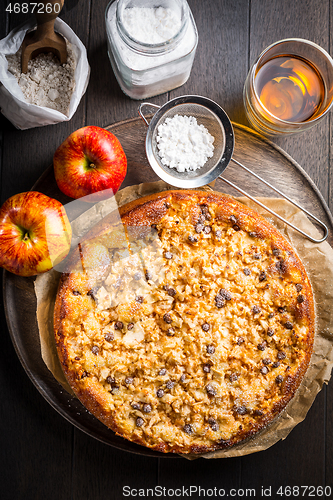 Image of Delicious apple pie with chocolate pieces and ingredients for Thanksgiving