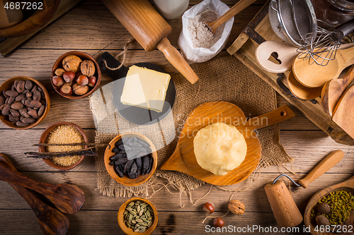 Image of Assortment of baking ingredients and kitchen utensils in vintage wooden style