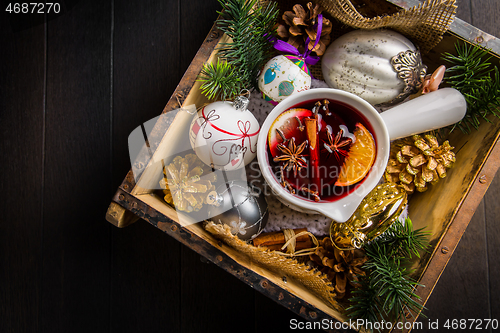 Image of Mulled wine with orange, cinnamon and anise in mug for Christmas