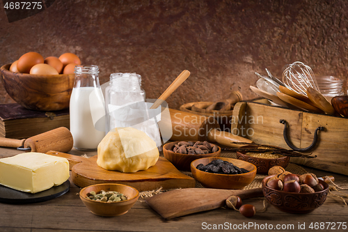 Image of Assortment of baking ingredients and kitchen utensils in vintage wooden style