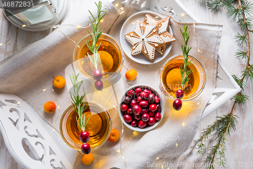 Image of Christmas apple cider cocktail with cranberries and rosemary