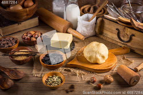 Image of Assortment of baking ingredients and kitchen utensils in vintage wooden style