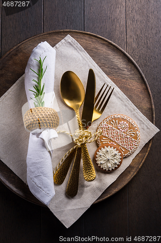 Image of Christmas table place setting with vintage silverware and gingerbread