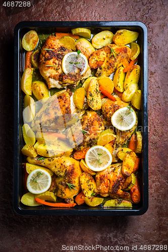 Image of Baked lemon chicken with potates, carrots and herbs