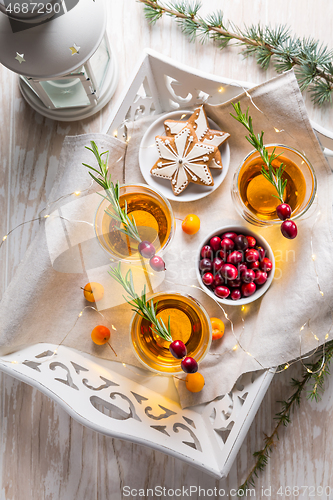 Image of Christmas apple cider cocktail with cranberries and rosemary