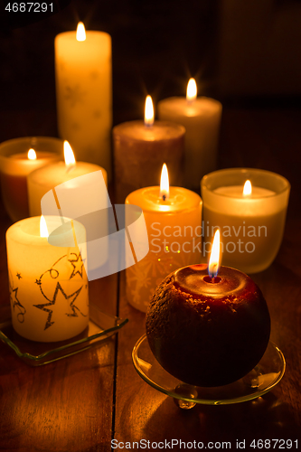 Image of Candles on wooden background. Candlelights for Christmas.