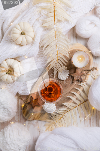 Image of Cosy still life for winter and autumn with glass of pink wine, pumpkin and cookie