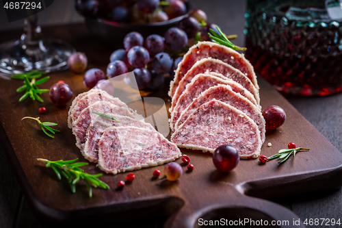 Image of Saltufo - Italian salami delicacy, salami with summer truffle coated with Parmesan cheese with red wine and grapes