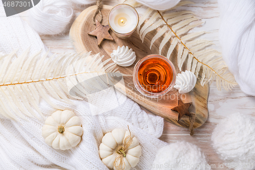 Image of Cosy still life for winter and autumn with glass of pink wine, pumpkin and cookie