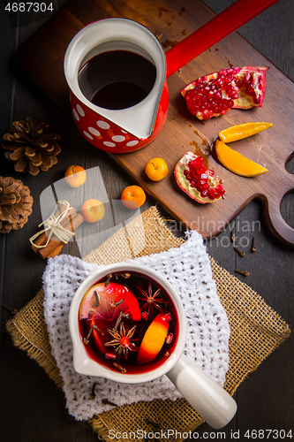 Image of Hot spicy mulled wine with fruits and spices in mug